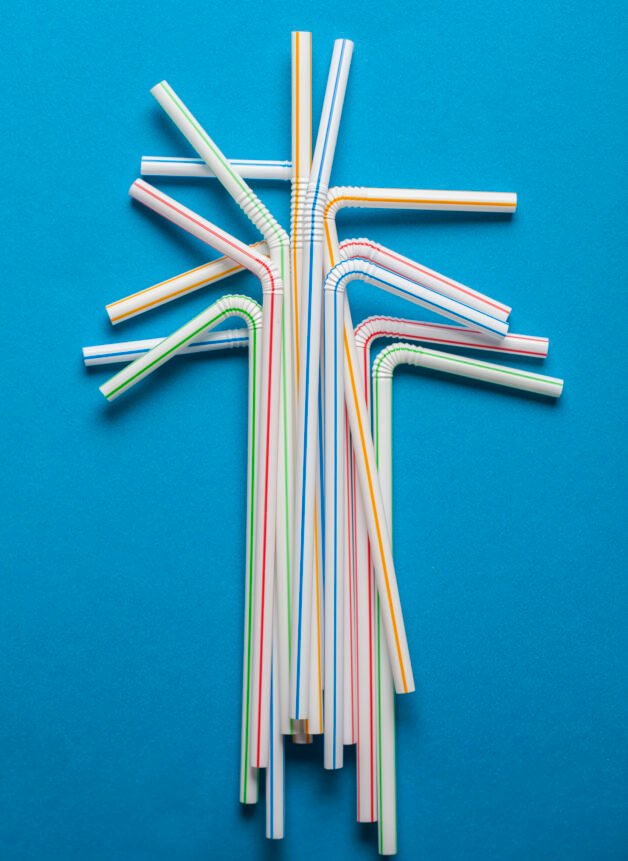 Plastic straws on a blue background